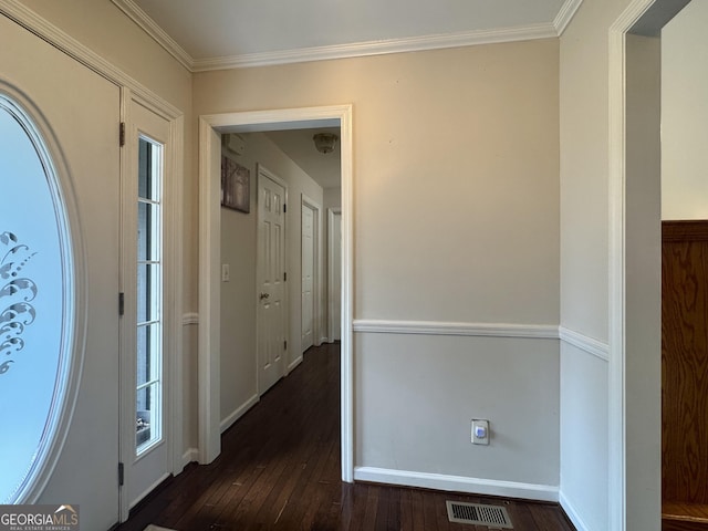 entrance foyer with crown molding and dark hardwood / wood-style floors