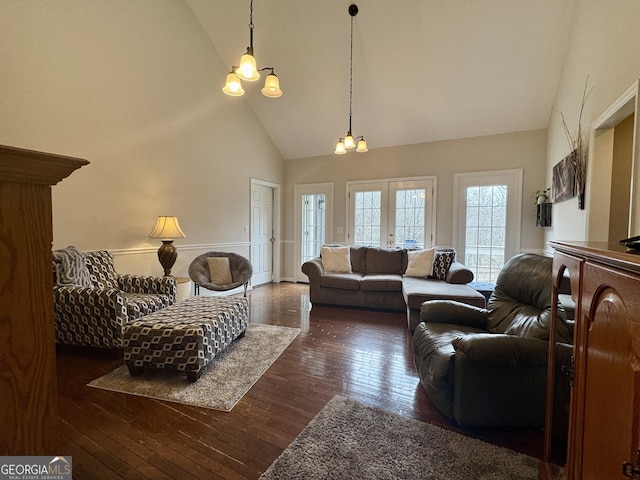 living room featuring dark wood-type flooring, high vaulted ceiling, and french doors