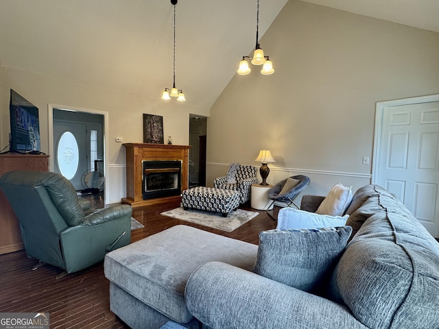 living room featuring an inviting chandelier, dark wood-type flooring, and high vaulted ceiling