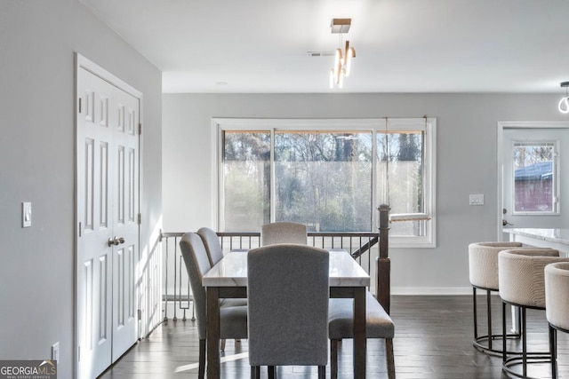 dining space with dark hardwood / wood-style flooring