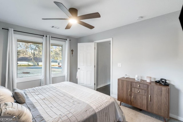 bedroom with ceiling fan and light carpet