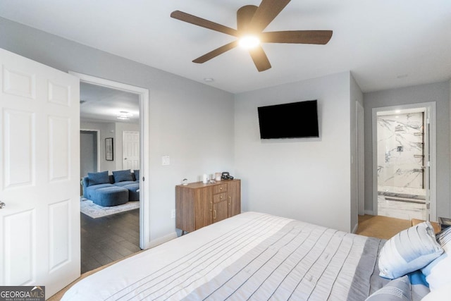 bedroom featuring ceiling fan, wood-type flooring, and ensuite bathroom