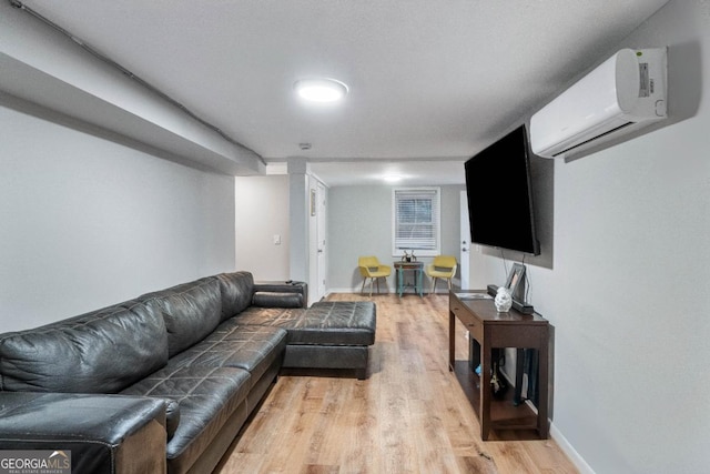 living room with light hardwood / wood-style floors and an AC wall unit