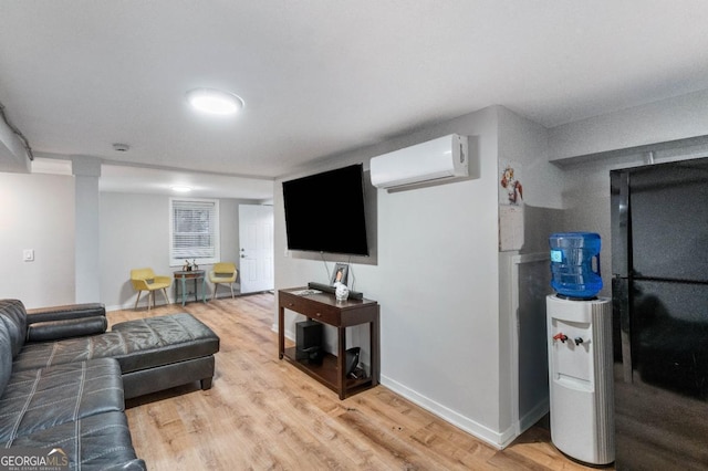 living room featuring a wall unit AC and light wood-type flooring