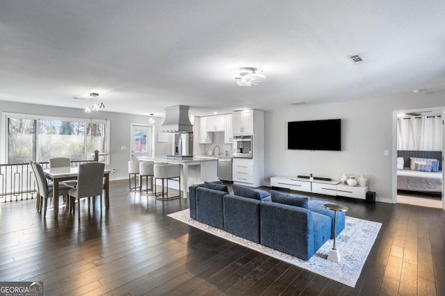 living room featuring dark hardwood / wood-style flooring and sink