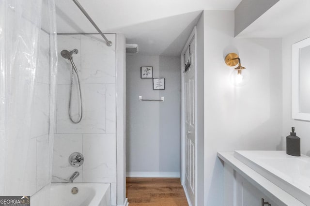 bathroom with shower / bath combo and wood-type flooring