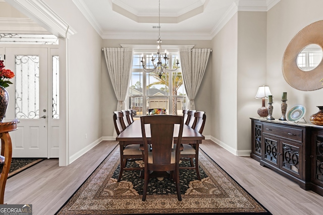 dining space with a chandelier, light hardwood / wood-style flooring, and a wealth of natural light