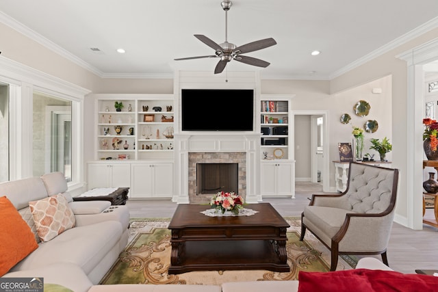 living room featuring ornamental molding, ceiling fan, and light wood-type flooring