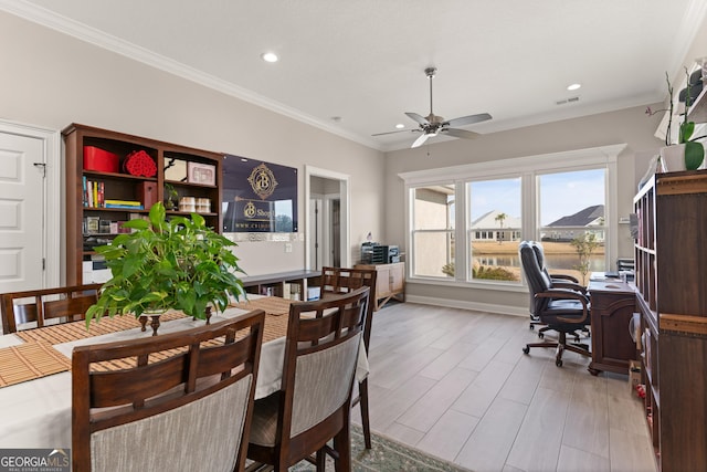 dining room featuring crown molding, ceiling fan, and light hardwood / wood-style floors