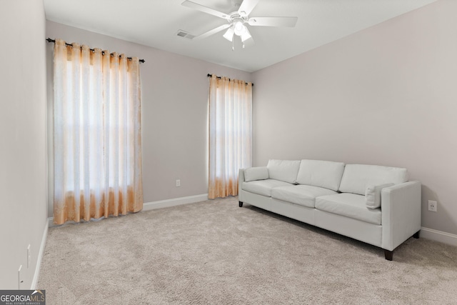 living room with light colored carpet and ceiling fan