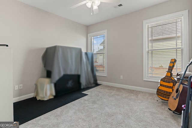 misc room with ceiling fan and light carpet