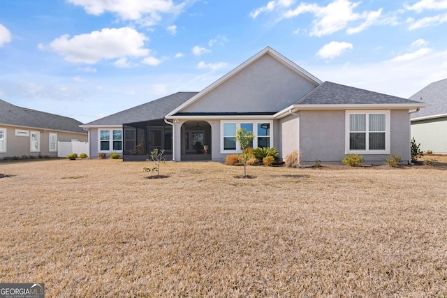 rear view of house featuring a lawn