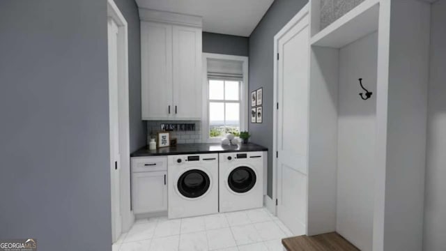 laundry area with cabinets and washer and clothes dryer