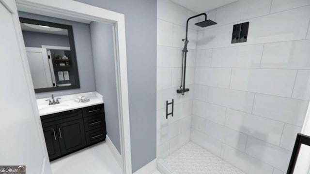 bathroom with vanity and tiled shower