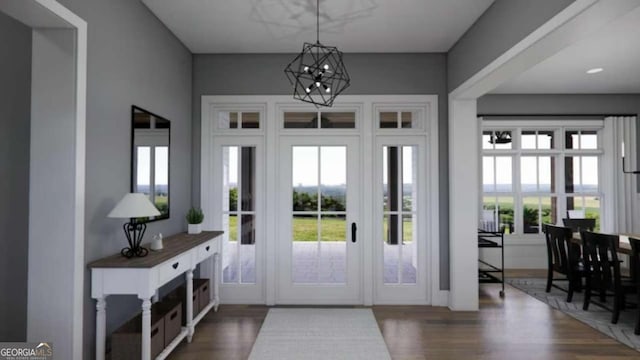 entrance foyer with dark hardwood / wood-style flooring and a chandelier