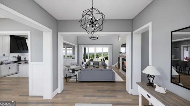 entrance foyer featuring wood-type flooring and a notable chandelier