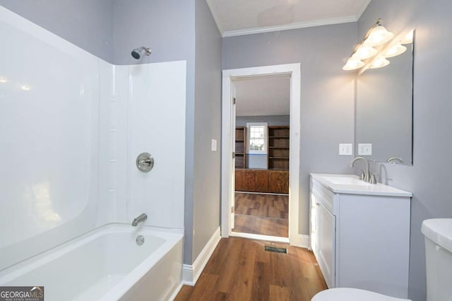 full bathroom with toilet, ornamental molding, shower / washtub combination, vanity, and hardwood / wood-style flooring