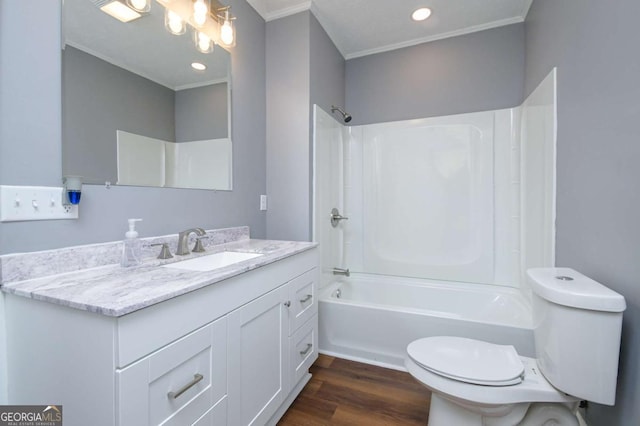 full bathroom with shower / tub combination, wood-type flooring, ornamental molding, vanity, and toilet