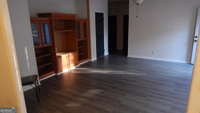 unfurnished living room with dark hardwood / wood-style flooring