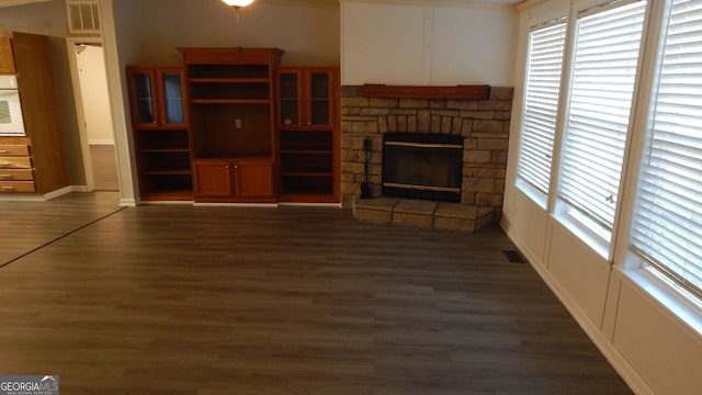 unfurnished living room with dark hardwood / wood-style flooring and a fireplace