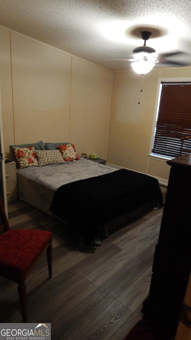 bedroom with hardwood / wood-style floors and a textured ceiling