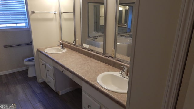 bathroom featuring vanity, toilet, and hardwood / wood-style floors