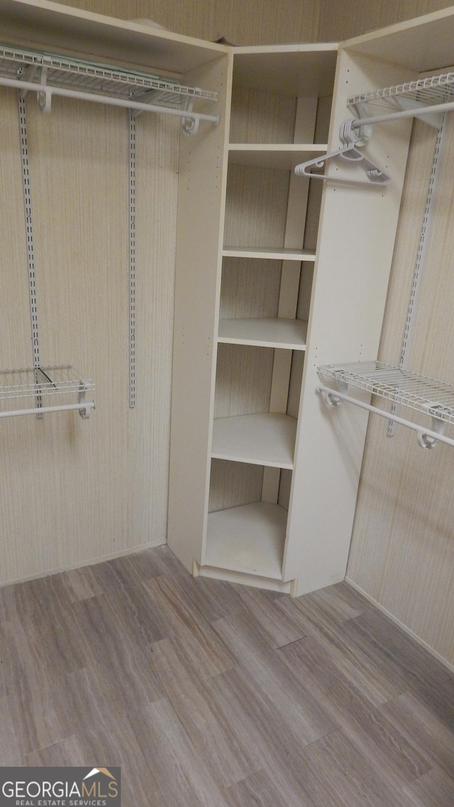 spacious closet featuring light hardwood / wood-style floors