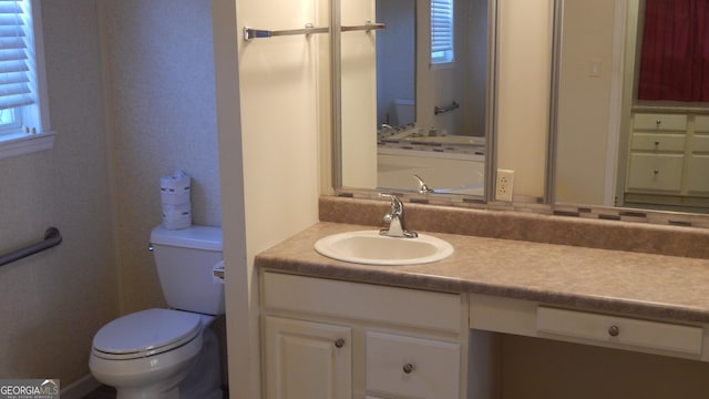 bathroom featuring vanity and toilet