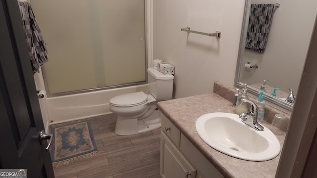 full bathroom with vanity, shower / bath combination with glass door, and toilet