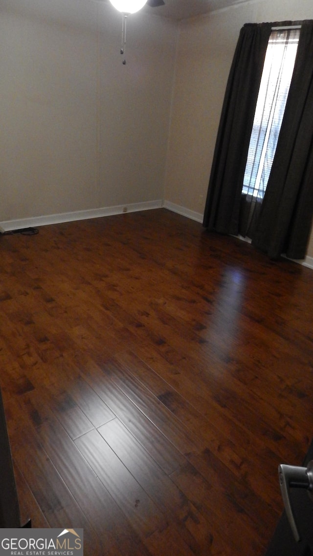 unfurnished room featuring dark hardwood / wood-style flooring