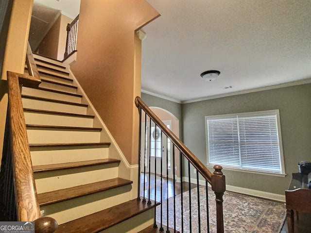 stairway featuring crown molding