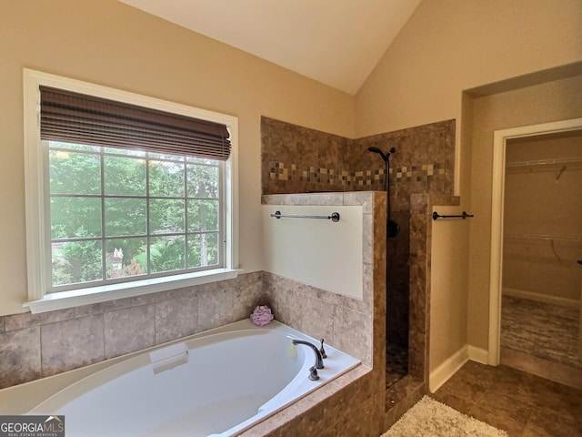 bathroom with lofted ceiling, tile patterned flooring, and separate shower and tub