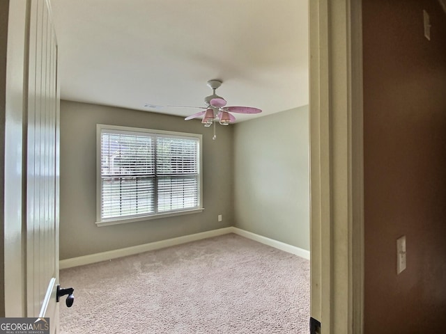 empty room with carpet floors and ceiling fan