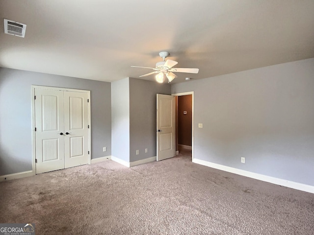 unfurnished bedroom featuring carpet floors, ceiling fan, and a closet