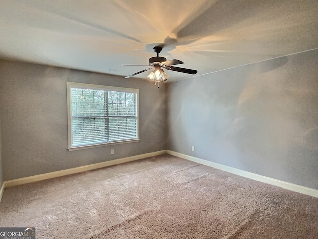 carpeted empty room featuring ceiling fan