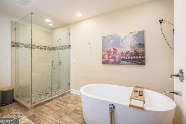 bathroom with separate shower and tub and hardwood / wood-style floors