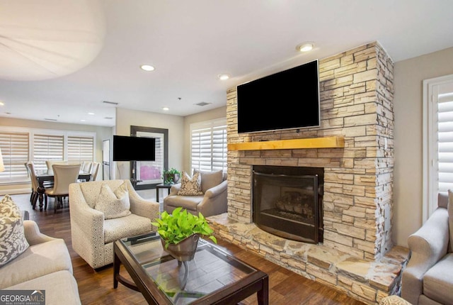 living room with hardwood / wood-style flooring and a fireplace