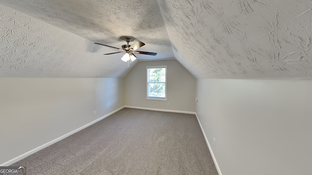 additional living space featuring ceiling fan, vaulted ceiling, carpet, and a textured ceiling