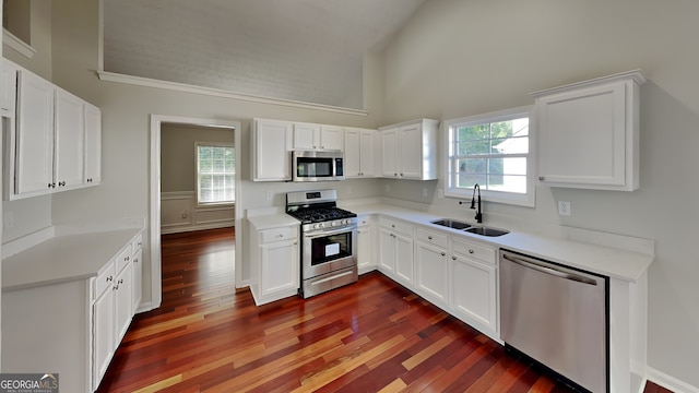 kitchen featuring stainless steel appliances, sink, and white cabinets