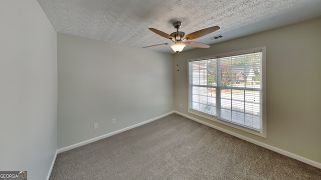 unfurnished room with ceiling fan, carpet floors, and a textured ceiling