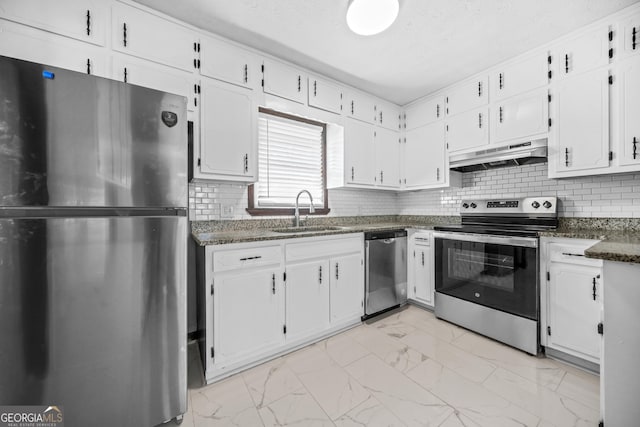 kitchen with white cabinetry, appliances with stainless steel finishes, sink, and backsplash