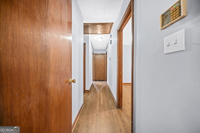 hallway with light hardwood / wood-style flooring