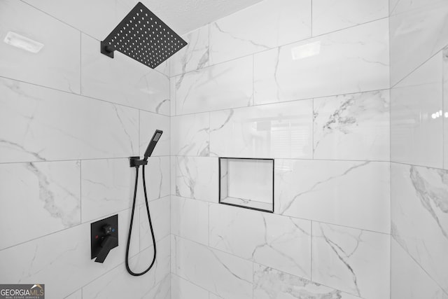 interior details with a tile shower