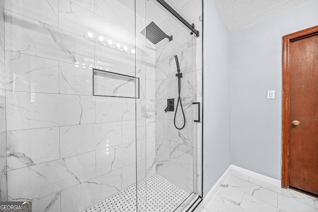 bathroom featuring a textured ceiling and a shower with shower door