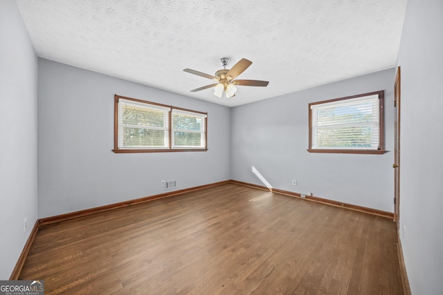 spare room featuring ceiling fan, hardwood / wood-style floors, and a textured ceiling