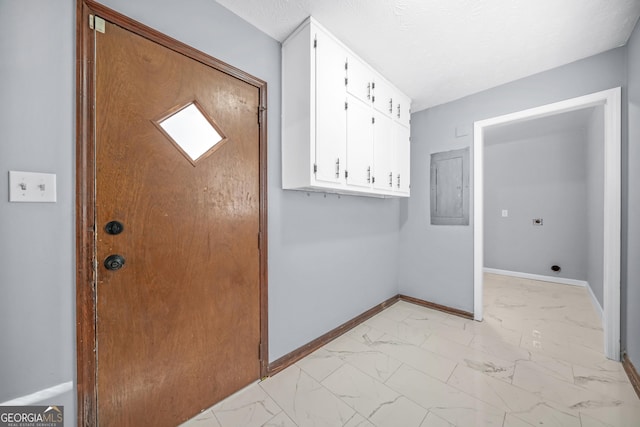 interior space featuring electric panel and a textured ceiling