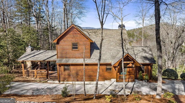 view of front of property with a mountain view and covered porch