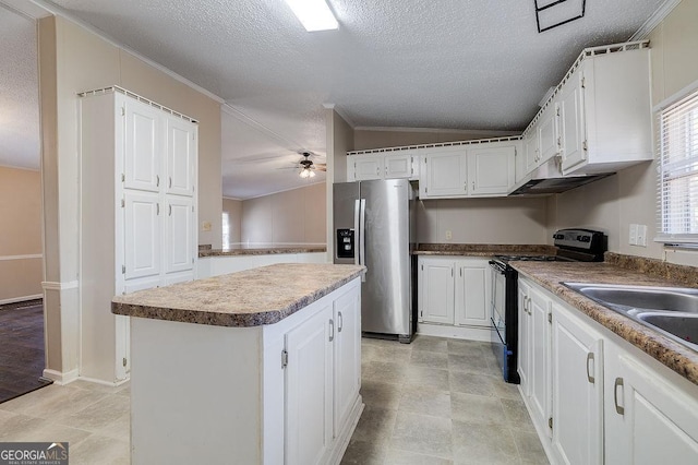 kitchen featuring ceiling fan, white cabinetry, a center island, stainless steel refrigerator with ice dispenser, and black / electric stove