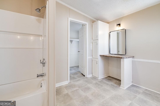 bathroom featuring crown molding, bathtub / shower combination, and a textured ceiling