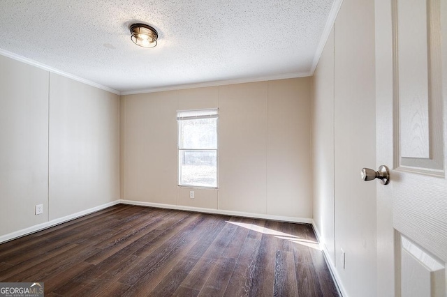 spare room with dark wood-type flooring, ornamental molding, and a textured ceiling